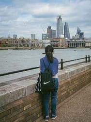 A girl gazing at the city skyline from London's South Bank.